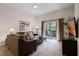 Living room with sofa, TV, and access to a balcony at 312 Lucaya Loop # B5/U312, Davenport, FL 33897