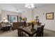 Open living room and dining area with access to a balcony at 312 Lucaya Loop # B5/U312, Davenport, FL 33897