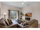Living room with sectional sofa, coffee table, and balcony access at 312 Lucaya Loop # B5/U312, Davenport, FL 33897