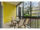 Screened balcony with yellow walls and patio furniture at 312 Lucaya Loop # B5/U312, Davenport, FL 33897
