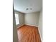 Bedroom with hardwood floors and a window with blinds at 3326 Robert Trent Jones Dr # 10102, Orlando, FL 32835