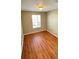 Bedroom with hardwood floors and a window with blinds at 3326 Robert Trent Jones Dr # 10102, Orlando, FL 32835