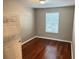 Bright bedroom with hardwood floors and a window with blinds at 3326 Robert Trent Jones Dr # 10102, Orlando, FL 32835