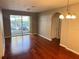 Living room with hardwood floors and sliding glass doors leading to a screened patio at 3326 Robert Trent Jones Dr # 10102, Orlando, FL 32835