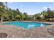 Refreshing community pool surrounded by lush landscaping at 3326 Robert Trent Jones Dr # 10102, Orlando, FL 32835