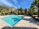 Inviting community pool with surrounding landscaping at 3326 Robert Trent Jones Dr # 10102, Orlando, FL 32835