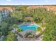 Community pool with surrounding patio and cabana at 3326 Robert Trent Jones Dr # 10102, Orlando, FL 32835