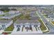 Aerial view of townhouses with parking and nearby lake at 4078 Malawi Trl, Saint Cloud, FL 34772