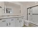 Bathroom with double vanity, large mirror, and a walk-in shower at 4078 Malawi Trl, Saint Cloud, FL 34772