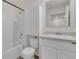 Clean bathroom with a bathtub, toilet and vanity with mirror at 4078 Malawi Trl, Saint Cloud, FL 34772