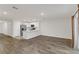Open living room with wood-look floors and access to a patio at 4078 Malawi Trl, Saint Cloud, FL 34772