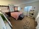 Second bedroom with unique wall decor and ample space at 4235 Edgewater Dr, Orlando, FL 32804