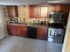 Updated kitchen featuring wood cabinets and stainless steel appliances at 4235 Edgewater Dr, Orlando, FL 32804