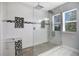 Modern bathroom featuring a glass-enclosed shower and mosaic tile accents at 4858 Stone Acres Cir, St Cloud, FL 34771