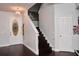 Inviting entryway showcases dark wood floors, a decorative front door, and a staircase at 4858 Stone Acres Cir, St Cloud, FL 34771