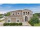 Stunning two-story home boasts a grand entrance, manicured landscaping, and timeless architectural details at 4858 Stone Acres Cir, St Cloud, FL 34771
