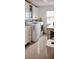 Bright laundry room with front-load washer and dryer, plus ample storage cabinets at 4858 Stone Acres Cir, St Cloud, FL 34771