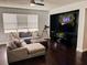Comfortable living room with large windows, a sectional sofa, dark wood floors and modern decor at 4858 Stone Acres Cir, St Cloud, FL 34771