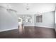 Spacious living room featuring gleaming hardwood floors and modern light fixtures at 4858 Stone Acres Cir, St Cloud, FL 34771