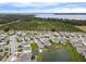 Aerial view of houses near a lake and citrus grove at 5052 Center Ct, St Cloud, FL 34772