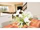 Elegant dining room with a wood table and white orchids centerpiece at 5052 Center Ct, St Cloud, FL 34772