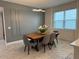 Dining room with a wood table and gray chairs, featuring marble flooring at 5052 Center Ct, St Cloud, FL 34772
