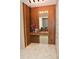 Elegant entryway with wood wall paneling, built-in shelving, and a large mirror at 5052 Center Ct, St Cloud, FL 34772