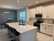 Modern kitchen with white cabinets, island, and stainless steel appliances at 5052 Center Ct, St Cloud, FL 34772