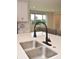 Modern kitchen sink and faucet with white quartz countertop at 5052 Center Ct, St Cloud, FL 34772