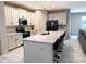 Modern kitchen with white cabinets, island, and stainless steel appliances at 5052 Center Ct, St Cloud, FL 34772