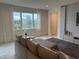Bright living room features large windows with lake view and comfortable seating at 5052 Center Ct, St Cloud, FL 34772