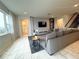 Spacious living room with large sectional sofa, tiled floors, and modern decor at 5052 Center Ct, St Cloud, FL 34772