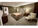 Spacious main bedroom with a plush bed, nightstands, an armchair, and soft carpet at 5052 Center Ct, St Cloud, FL 34772
