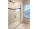 Glass shower with tile surround and window at 5052 Center Ct, St Cloud, FL 34772