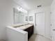 Double vanity bathroom with granite countertop and large mirror at 524 Sardinia Cir, Davenport, FL 33837