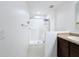 Bright bathroom with shower, tile surround, and linen storage at 524 Sardinia Cir, Davenport, FL 33837