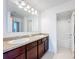 Bathroom with double vanity, granite countertop, and tub at 524 Sardinia Cir, Davenport, FL 33837