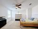 Bright bedroom with wood bed frame, ceiling fan, and window coverings at 524 Sardinia Cir, Davenport, FL 33837