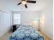 Bedroom with a queen bed, window, and floor lamp at 524 Sardinia Cir, Davenport, FL 33837