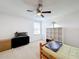 Bedroom with ceiling fan, window, and shelving unit at 524 Sardinia Cir, Davenport, FL 33837