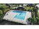 L-Shaped community pool with surrounding patio at 524 Sardinia Cir, Davenport, FL 33837