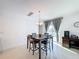 Bright dining room with wooden table and four chairs at 524 Sardinia Cir, Davenport, FL 33837