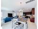 Open concept dining area with wood table and view into living room at 524 Sardinia Cir, Davenport, FL 33837