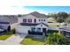 Two-story house with attached garage, manicured lawn, and red shutters at 524 Sardinia Cir, Davenport, FL 33837