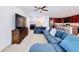 Living room with sectional sofa and view into kitchen at 524 Sardinia Cir, Davenport, FL 33837