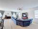 Living room with sectional sofa and large flat-screen TV at 524 Sardinia Cir, Davenport, FL 33837