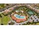 Aerial view of community pool, tennis court, and homes at 5505 Misty Oak Cir, Davenport, FL 33837