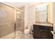 Modern bathroom with shower, granite vanity, and updated fixtures at 5505 Misty Oak Cir, Davenport, FL 33837