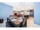 Dining room with dark wood table and chairs, view of kitchen at 5505 Misty Oak Cir, Davenport, FL 33837