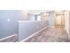 Upstairs hallway with neutral carpeting and painted walls at 5505 Misty Oak Cir, Davenport, FL 33837